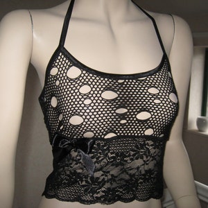May include: Black halter top with a lace bottom and a mesh top with large holes. The top is on a white mannequin.