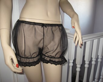 May include: Black sheer lingerie with a ruffled trim and black lace. The lingerie is made of a soft, delicate fabric and has a comfortable fit.