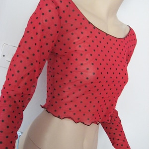 May include: Red sheer top with black polka dots and a scalloped hem.