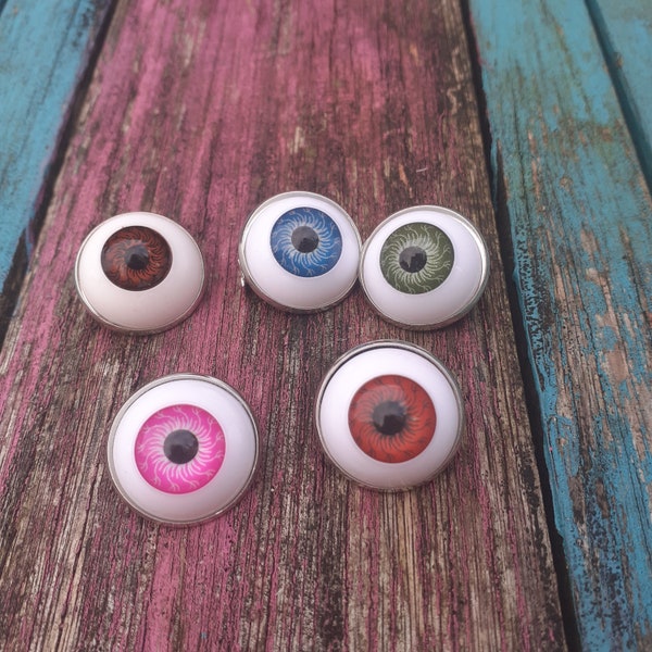 creepy doll eye brooches pins different colours. 20mm across.