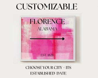 May include: A customizable art print with a pink and white abstract background. The print features a black arrow pointing to the right, with the text "FLORENCE ALABAMA EST. 1826".