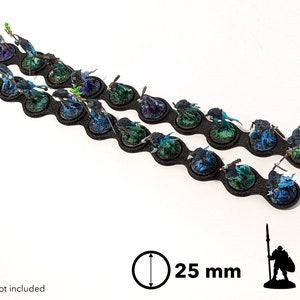 May include: Twenty 25 mm round bases for miniature figures. The bases are black with a textured surface and have a blue and green paint effect.  The bases are arranged in two rows of ten.