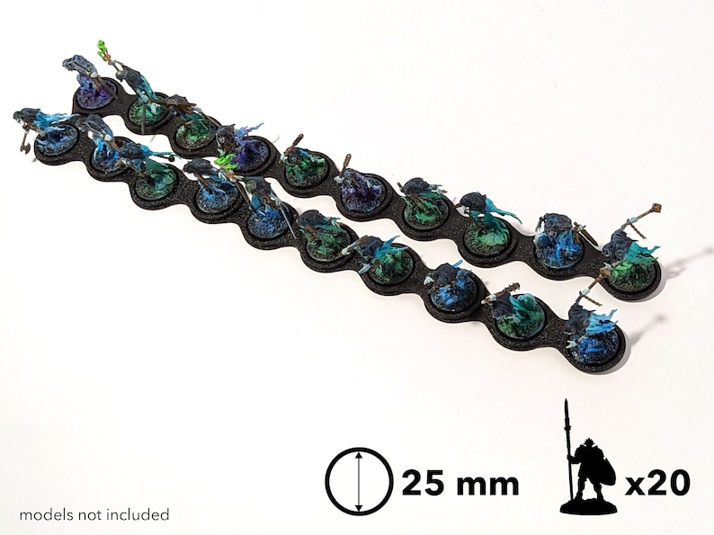 May include: Twenty 25 mm round bases for miniature figures. The bases are black with a textured surface and have a blue and green paint effect.  The bases are arranged in two rows of ten.