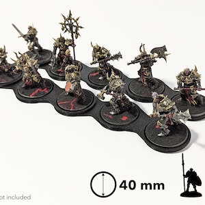 May include: Ten 40 mm round black plastic bases with red accents, designed to hold miniature figures. The bases are arranged in a row and feature a textured surface.  Models not included.