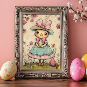 May include: A framed illustration of a girl dressed as a chick holding an egg. The frame is silver with ornate details. The illustration is on a light pink background. There are four Easter eggs on a wooden table in front of the frame.