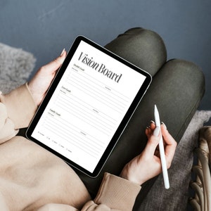 May include: A digital vision board template on a tablet with sections for health, love, and family goals. The tablet is being held by a person with a white stylus.