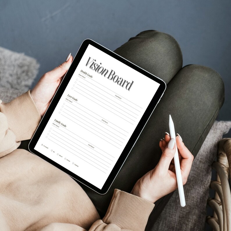 May include: A digital vision board template on a tablet with sections for health, love, and family goals. The tablet is being held by a person with a white stylus.