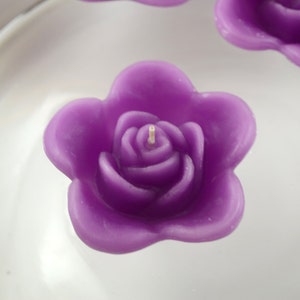 10 Raspberry floating rose wedding candles for table centerpiece and reception decor.