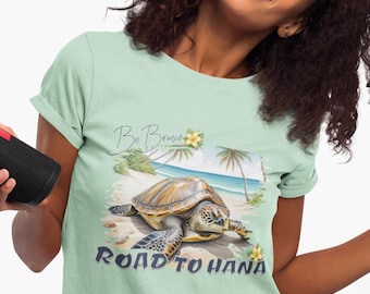 May include: A light green t-shirt featuring a sea turtle illustration and the text "Be Brave" and "Road to Hana".