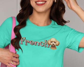 May include: A turquoise blue t-shirt with the text "French" in pink and gold lettering. A cartoon image of a brown poodle is to the right of the text.