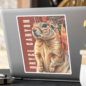 May include: A sticker featuring a detailed illustration of a ground squirrel with a Bryce Canyon background. The sticker has the text "BRYCE CANYON" in white and "EST. 1928" in a vintage style.