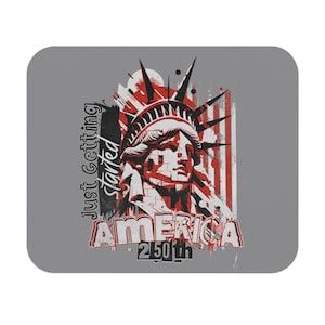 May include: Gray mousepad featuring a graphic of the Statue of Liberty in red and white with the word "AMERICA" and "250th". The text "Just Getting Started" is printed vertically on the left side. The design has a distressed, vintage look.