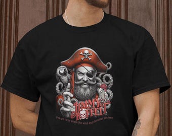 May include: Black t-shirt with a graphic of a pirate with a red bandana, an eyepatch, and a parrot on his shoulder. The text "Jimmy Buffett" is printed below the pirate with the words "I've got to be where the wind and the water are free".