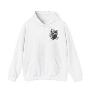 Könnte beinhalten: Weißer Kapuzenpullover mit einem schwarz-weißen Grafikdruck eines geflügelten Wesens mit einem Speer auf der linken Brust.