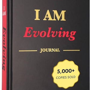 May include: A black journal with the words "I AM Evolving" in gold and red lettering. The journal's spine is red, and it includes the text "JOURNAL" and "5,000+ COPIES SOLD". The journal's cover also includes the text "Set Goals, Embrace Gratitude, Cultivate Habits, Achieve Inner Peace".