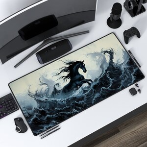 May include: A black horse with a flowing mane leaps out of a stormy sea. The waves are a dark blue and white, and the horse is silhouetted against a light background. This is a large, rectangular mousepad with a detailed design.