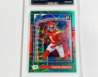 May include: A graded trading card featuring Xavier Worthy in a Kansas City Chiefs uniform. The card is a 2024 Donruss Optic Green Velocity, graded GEM MT 10. The card is encased in a clear protective holder.