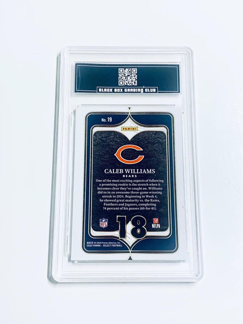 May include: A graded Caleb Williams football card, featuring the Chicago Bears logo. The card is encased in a clear plastic holder with the text "BLACK BOX GRADING CLUB" at the top. The card details Williams' performance.