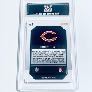May include: A Caleb Williams football card, graded and encased in a protective holder. The card features the Chicago Bears logo and the text "CALEB WILLIAMS". The holder has the text "BLACK BOX GRADING CLUB" at the top.