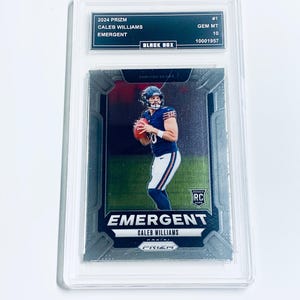 May include: A graded 2024 Prizm Caleb Williams Emergent football card. The card features a player in a Chicago Bears uniform. The card is encased in a protective holder with the text "BLACK BOX" and "GEM MT 10".