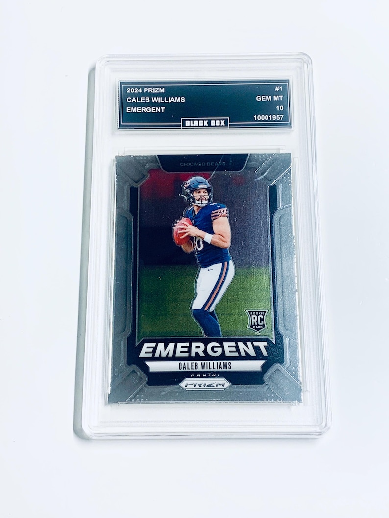 May include: A graded 2024 Prizm Caleb Williams Emergent football card. The card features a player in a Chicago Bears uniform. The card is encased in a protective holder with the text "BLACK BOX" and "GEM MT 10".