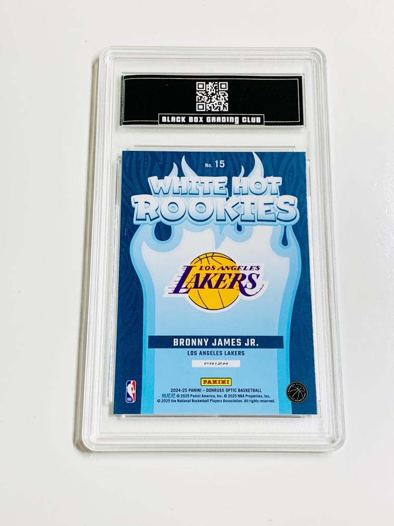 May include: A basketball trading card featuring Bronny James Jr. of the Los Angeles Lakers, part of the White Hot Rookies series. The card is encased in a clear protective holder, with the Panini and NBA logos visible.