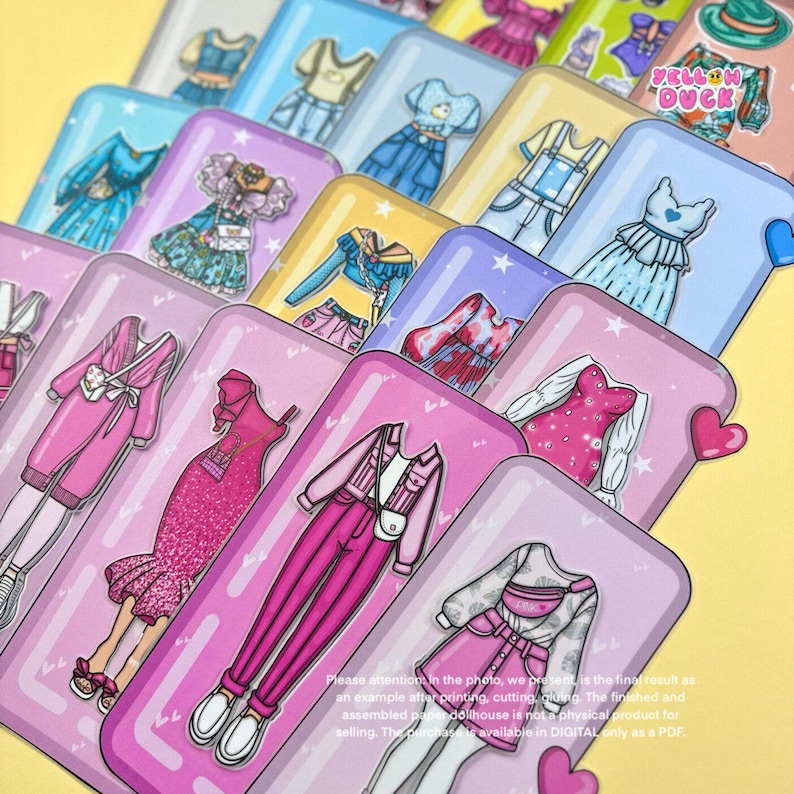 May include: A collection of colorful paper doll outfits on rectangular cards. The outfits include dresses, tops, and pants in various styles and colors, such as pink, blue, and white. The cards have a pink and purple background with hearts and stars. Text on the cards reads "YELLOW DUCK".
