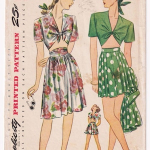 May include: Vintage Simplicity pattern 1020, size 14, bust 32. The illustration shows two women in 1940s-style outfits: a floral crop top and skirt, and a green crop top and polka dot skirt. The pattern details are printed on the front.