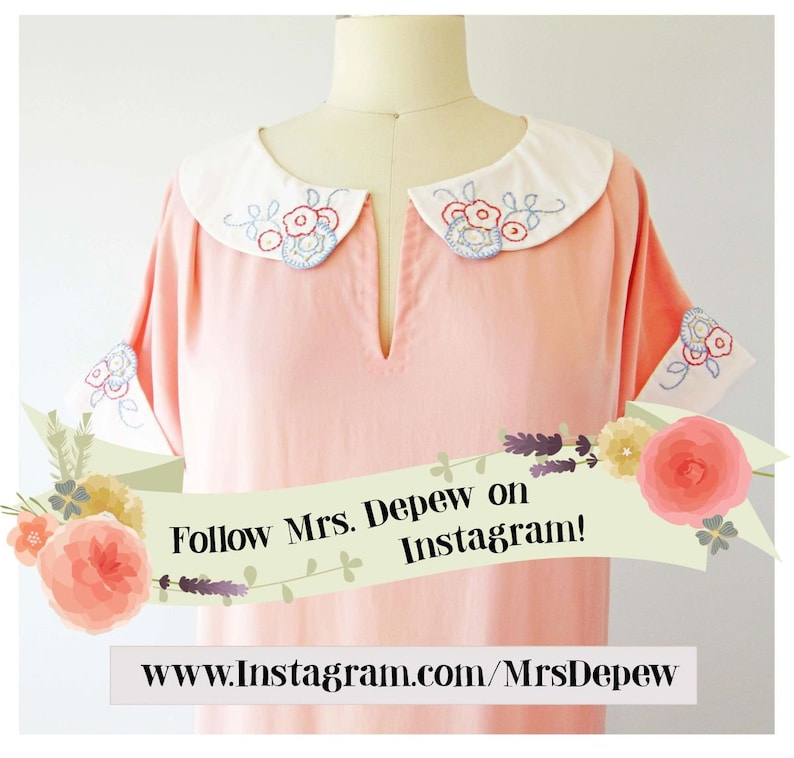May include: A light pink dress with a white collar and cuffs. The collar and cuffs are embroidered with blue, red, and yellow floral designs. The dress has short sleeves and a v-neck. The image includes the text "Follow Mrs. Depew on Instagram!" and a website address.