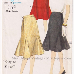 May include: Vintage Vogue sewing pattern featuring three skirt designs. The pattern includes a red skirt with a belt, a yellow skirt, and a black skirt. The pattern is labeled "Easy to Make" and includes waist and hip measurements.
