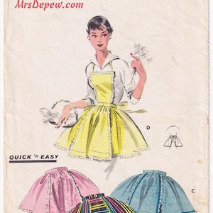 May include: A vintage Butterick 7539 sewing pattern envelope featuring illustrations of four apron styles. The designs include a yellow polka dot apron, a pink apron, a blue apron, and a multi-colored striped apron, all with ruffled trim details.