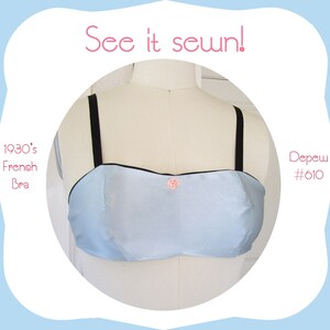 May include: A light blue bra with black straps and a small pink rose detail. The bra is a 1930's French style bra. See it sewn! Depew #610