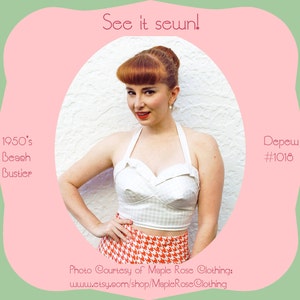 May include: A white halter top with a gingham pattern and a red and white houndstooth skirt. The top has a sweetheart neckline and is cropped. The skirt is high-waisted and has a full skirt. The model is wearing the outfit and has red hair and is smiling. The image is captioned "See it sewn!" and "1950's Beach Bustier" and "Depew #1018".
