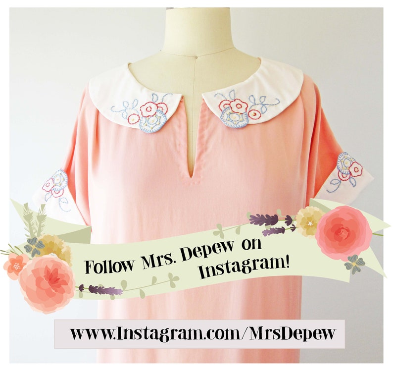 May include: A light pink dress with a white collar and cuffs, adorned with embroidered floral designs in red, blue, and yellow. The dress has short sleeves and a V-neck. The text "Follow Mrs. Depew on Instagram!" is displayed on a banner.
