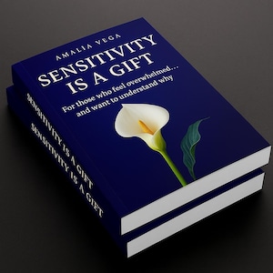 May include: Two books titled "SENSITIVITY IS A GIFT" by Amalia Vega. The cover is dark blue with white text and a white calla lily illustration. The text on the cover reads "For those who feel overwhelmed... and want to understand why."