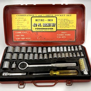 May include: A vintage red metal toolbox containing a 40-piece socket set. The set includes various chrome-plated sockets, a ratchet handle, extension, nut driver, and spark plug socket. The toolbox has a yellow and red label with the text "METRIC-INCH".
