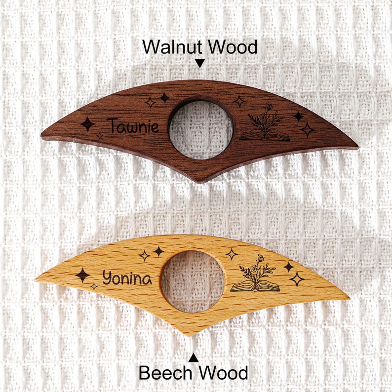 May include: Two wooden book page holders, one walnut and one beech. The walnut holder has the name "Tawnie" and the beech holder has the name "Yonina". Both have a circular opening and star and floral designs.