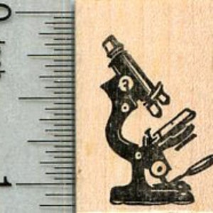 May include: A black and white silhouette of a microscope on a wooden background. The microscope has a round base, a long arm, and a lens at the top.