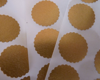 May include: A sheet of gold-coloured, scalloped round stickers on a white background.