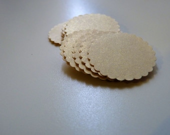 May include: A stack of round, scalloped, beige paper circles.