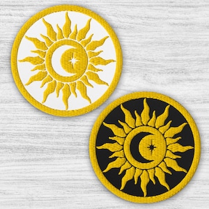 May include: Two embroidered patches with a sun and crescent moon design. One patch has a white background with a yellow sun and moon, the other has a black background with a yellow sun and moon.