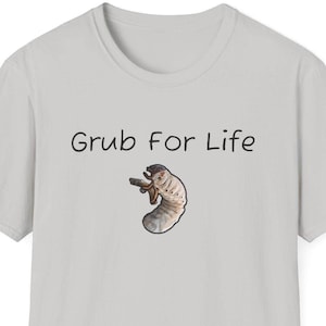 May include: A light gray t-shirt with the text "Grub For Life" printed in black. A small image of a white grub is printed below the text.