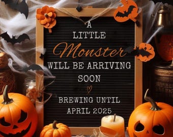 May include: Halloween-themed announcement with pumpkins, candles, and a letter board. The board reads "A Little Monster Will Be Arriving Soon Brewing Until April 2025." Orange and black decorations include bats and banners.