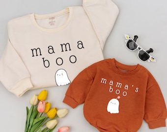 May include: A set of two cream colored sweatshirts with a ghost and the text "mama boo" and "mama's boo" printed on them. The smaller sweatshirt is rust colored.