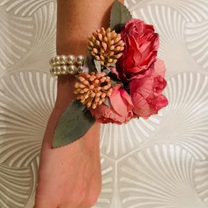 Pink flower wedding wrist corsage with elasticated pearl bracelet.