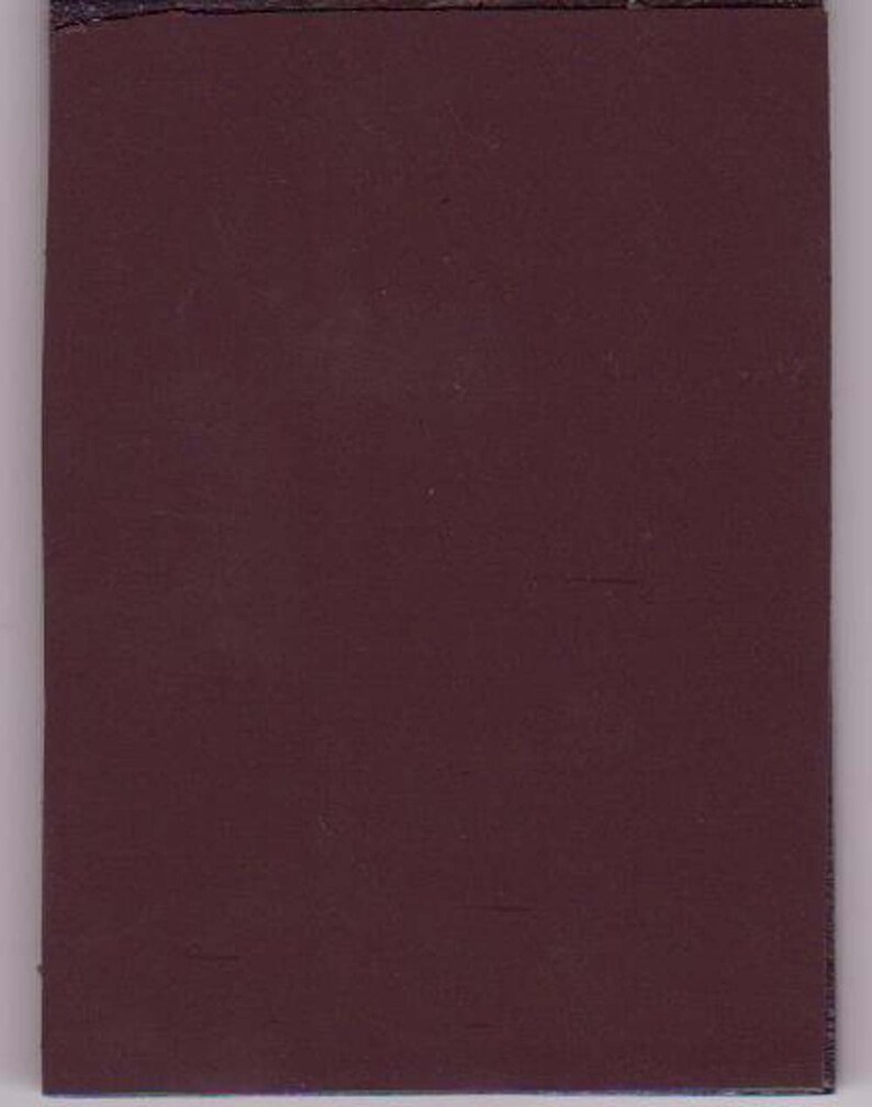 Puede incluir: Una cubierta de libro de color marr&oacute;n oscuro.