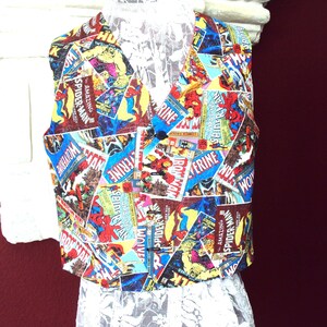 May include: A colorful vest featuring comic book covers with characters like Spider-Man, Wolverine, and Iron Man. The vest has a V-neck, a button closure, and is made of a patchwork of comic book panels. The vest is a vibrant mix of red, blue, yellow, and brown.
