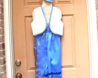 May include: A blue and white costume, including a vest, pants, and a hat, is displayed on a mannequin. The costume features a white vest with blue trim, blue pants, and a matching hat. The pants have a decorative trim.