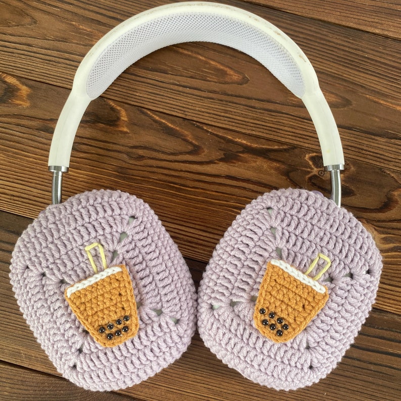 May include: Purple crocheted headphone covers with a brown and yellow crocheted boba tea design on each earcup.