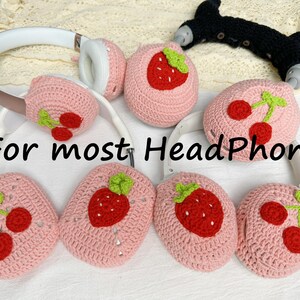 May include: Pink crocheted headphone covers with strawberry and cherry designs.  For most HeadPhone.